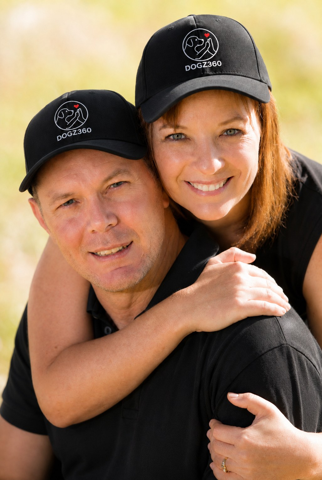 Two trainers in matching caps sharing a warm hug